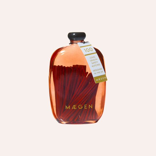 A bottle of MÄGEN red bubble safety matches with a black cap 